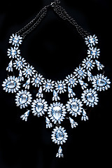 Image showing blue necklace on a black background. gems. 