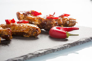 Image showing fried chicken wings on a black slate plate 