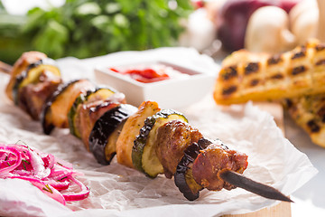 Image showing shish kebab on skewers with onions and vegetables. 