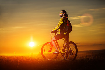 Image showing Sporty Man Riding a Bicycle on the Country Road.