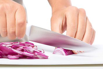 Image showing Cook is chopping onion