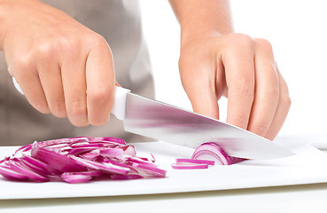 Image showing Cook is chopping onion