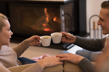 Image showing Young couple  in front of fireplace