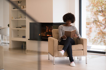 Image showing black woman at home reading book