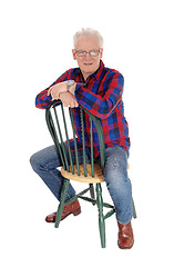 Image showing A happy senior man sitting on chair.