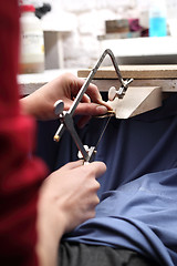 Image showing Creating jewelry. Manually creating jewelry. Jeweler's workshop. Jeweler saws blade.