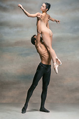 Image showing Couple of ballet dancers posing over gray background