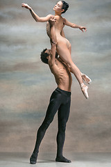 Image showing Couple of ballet dancers posing over gray background