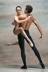 Image showing Couple of ballet dancers posing over gray background