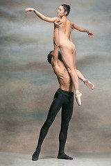 Image showing Couple of ballet dancers posing over gray background