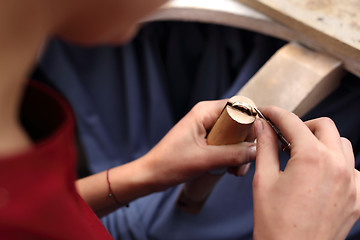 Image showing Creating artistic jewelery. Jeweler at work.