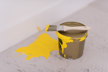 Image showing Yellow paint tin can with brush on top