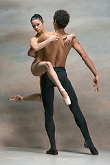 Image showing Couple of ballet dancers posing over gray background