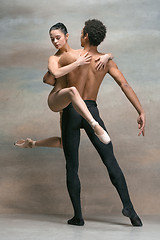 Image showing Couple of ballet dancers posing over gray background