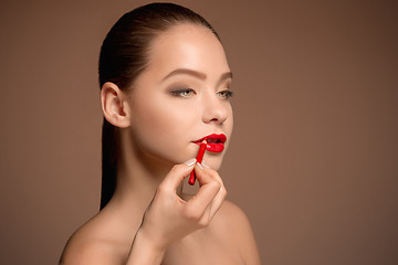 Image showing Beautiful female lips with make-up and brush