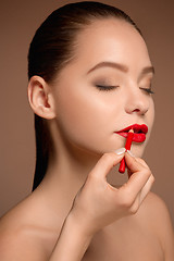 Image showing Beautiful female lips with make-up and brush