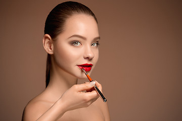 Image showing Beautiful female lips with make-up and brush