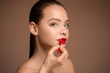 Image showing Beautiful female lips with make-up and brush