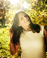 Image showing mature real brunette woman in green spring park, lifestyle conce