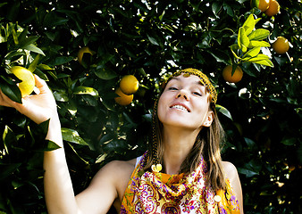 Image showing pretty islam woman in orange grove smiling, real muslim girl che