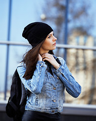 Image showing young pretty girl near business building walking