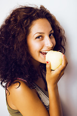 Image showing pretty young real tenage girl eating apple close up smiling