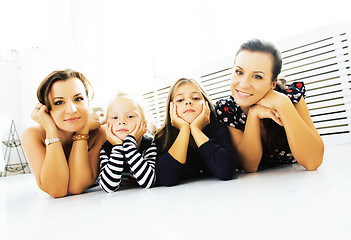 Image showing Mature sisters twins at home with little daughter, happy family 