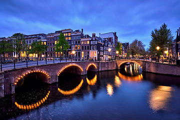 Image showing Amterdam canal, bridge and medieval houses in the evening