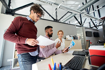 Image showing business team with tablet pc and papers in office