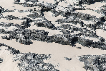 Image showing close up of stone or volcanic rock with sand