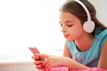 Image showing close up of girl with smartphone and headphones