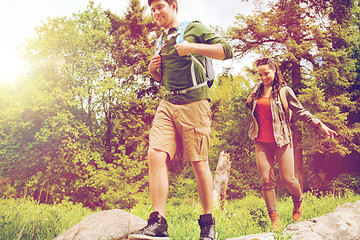 Image showing happy couple with backpacks hiking outdoors