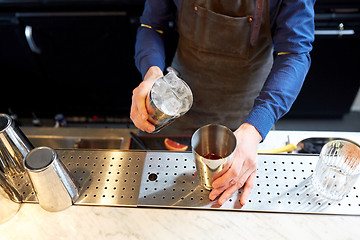 Image showing bartender with ice and shaker at cocktail bar