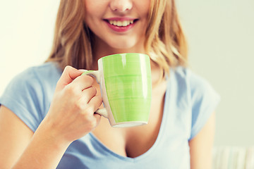 Image showing happy woman or teen girl drinking tea from cup