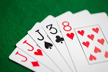 Image showing poker hand of playing cards on green casino cloth