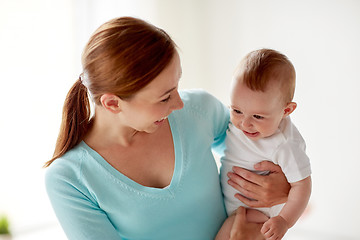 Image showing happy young mother with little baby at home