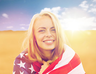 Image showing happy woman in american flag on cereal field