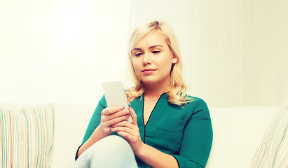 Image showing happy woman with smartphone at home