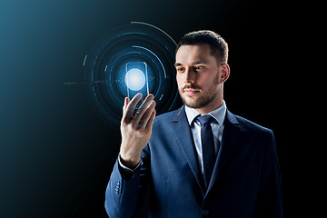 Image showing businessman with transparent smartphone