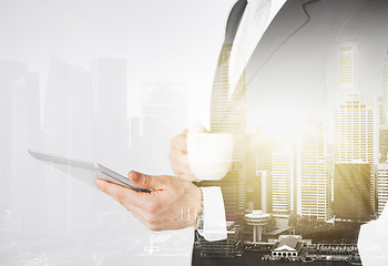 Image showing close up of businessman with tablet pc and coffee