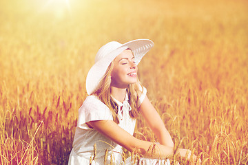 Image showing happy young woman in sun hat on cereal field