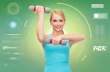 Image showing happy sporty woman with dumbbells flexing biceps