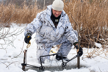 Image showing hunter putting a trap