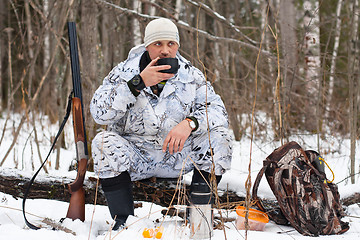 Image showing hunter during the rest on winter hunting