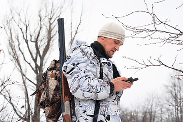 Image showing hunter looking on the mobile  navigation device