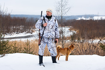 Image showing hunter with dog in winter