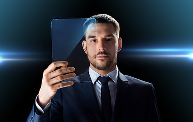 Image showing businessman working with transparent tablet pc