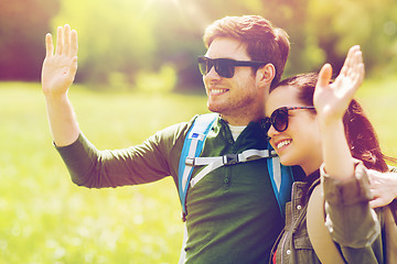 Image showing happy couple with backpacks hiking outdoors