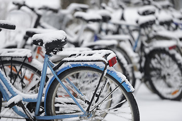 Image showing snow covered bikes in the parking lot