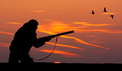 Image showing the silhouette of a hunter at sunset